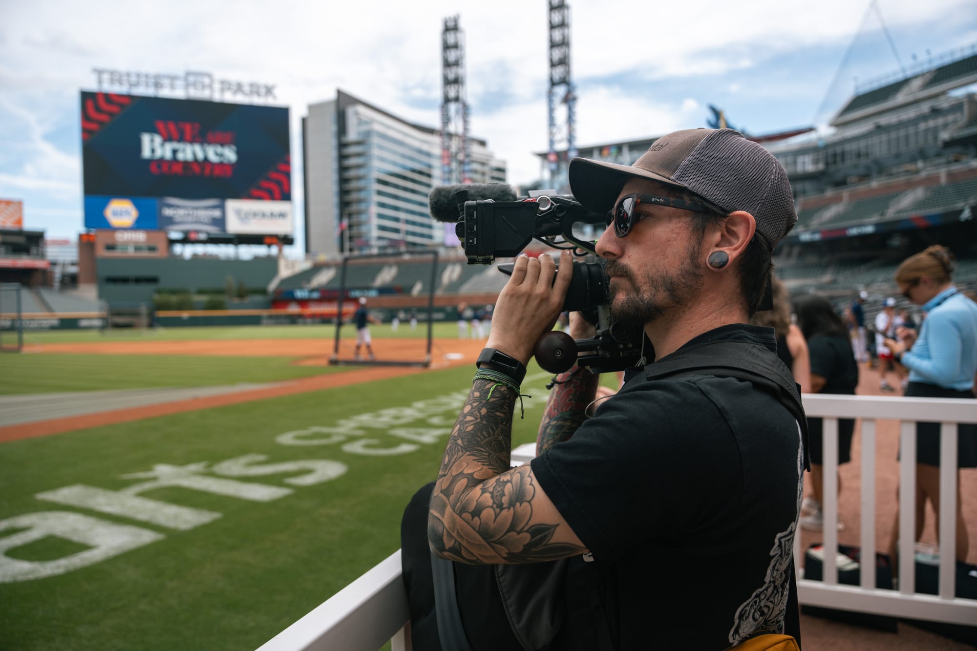Camera operator filming fans in the stands
