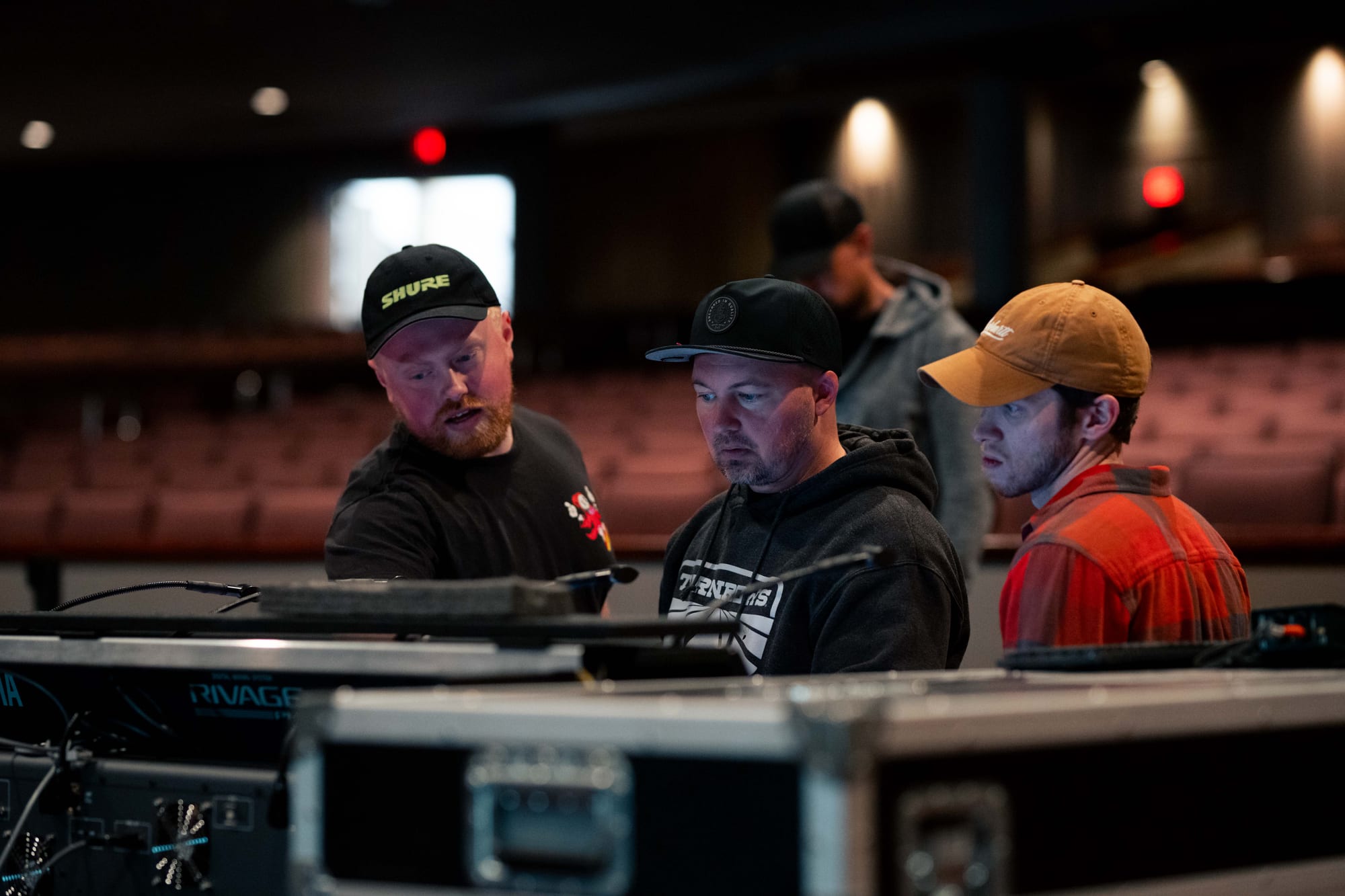 Audio crew reviewing the mixing console