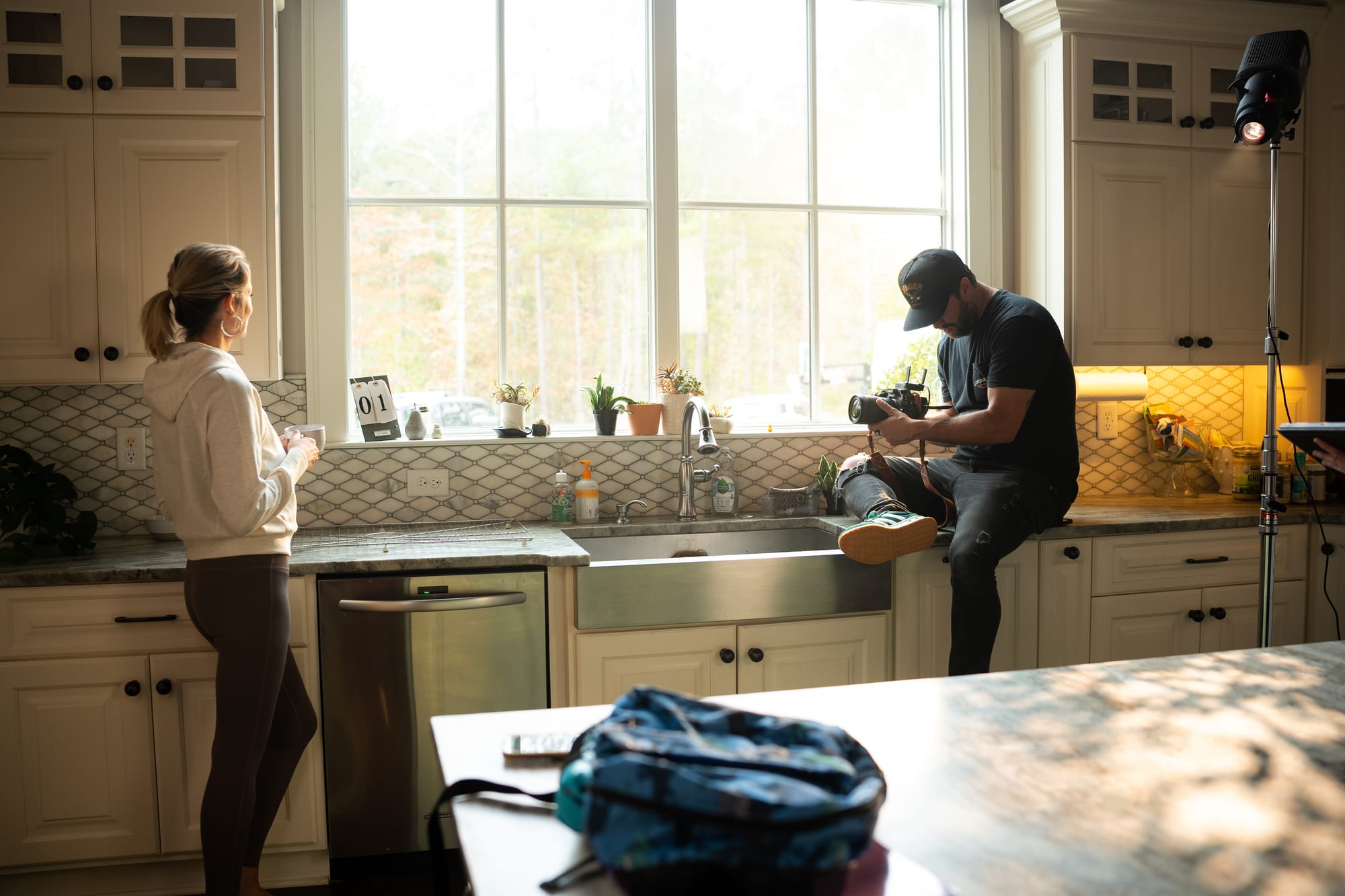 Full crew reviewing a shot in a living room