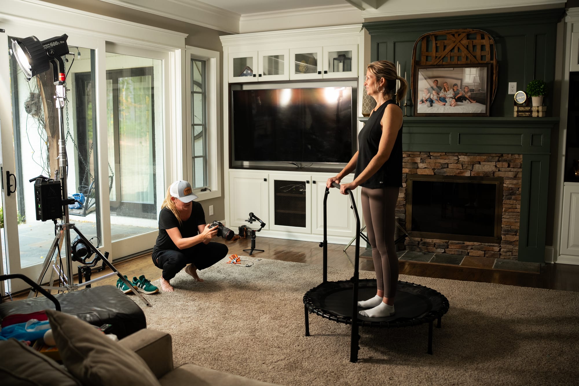 Camera operator with gimbal rig in living room