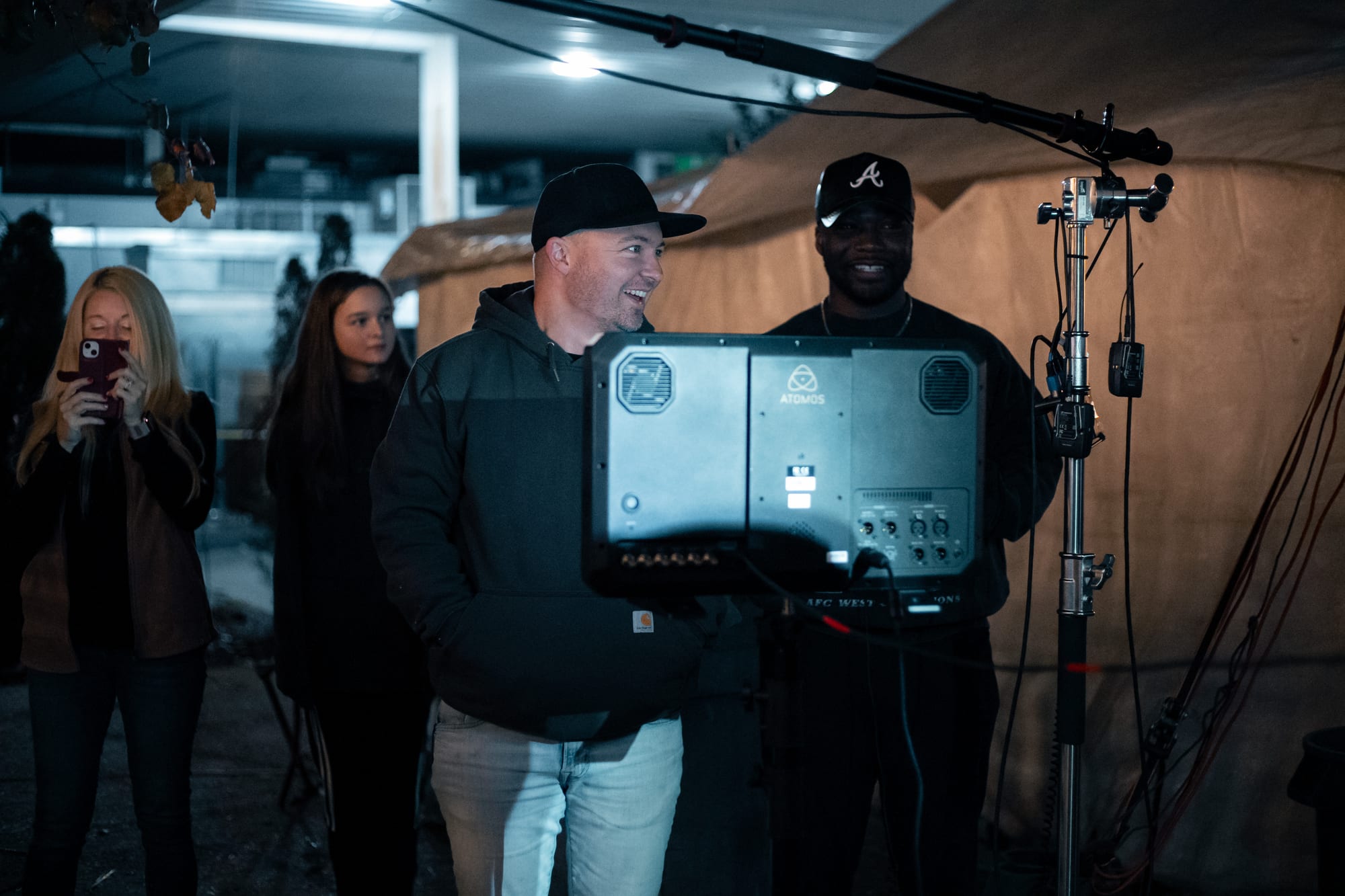 Crew laughing while checking a monitor on a night shoot