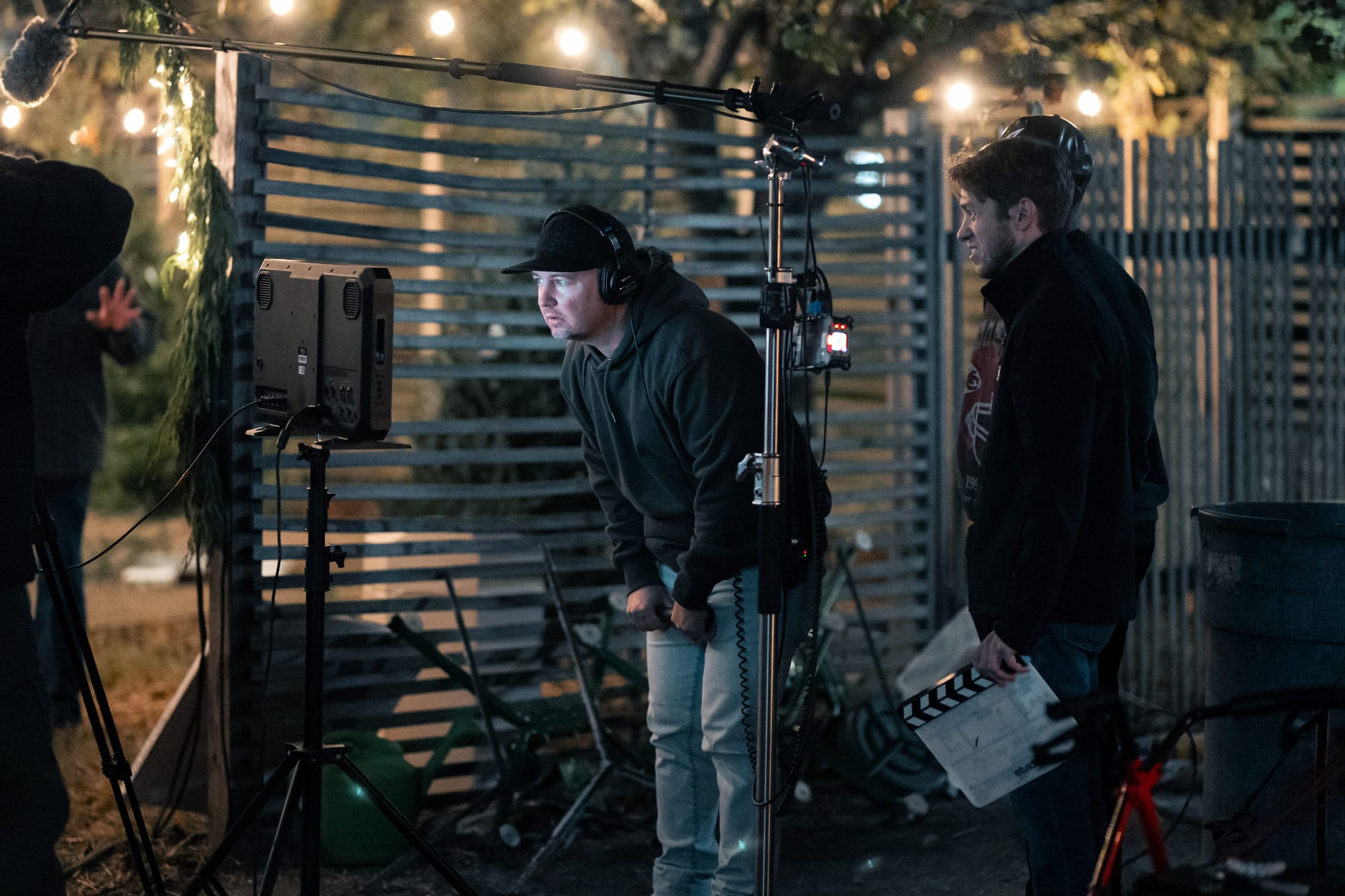 Sound mixer monitoring audio on a night exterior set