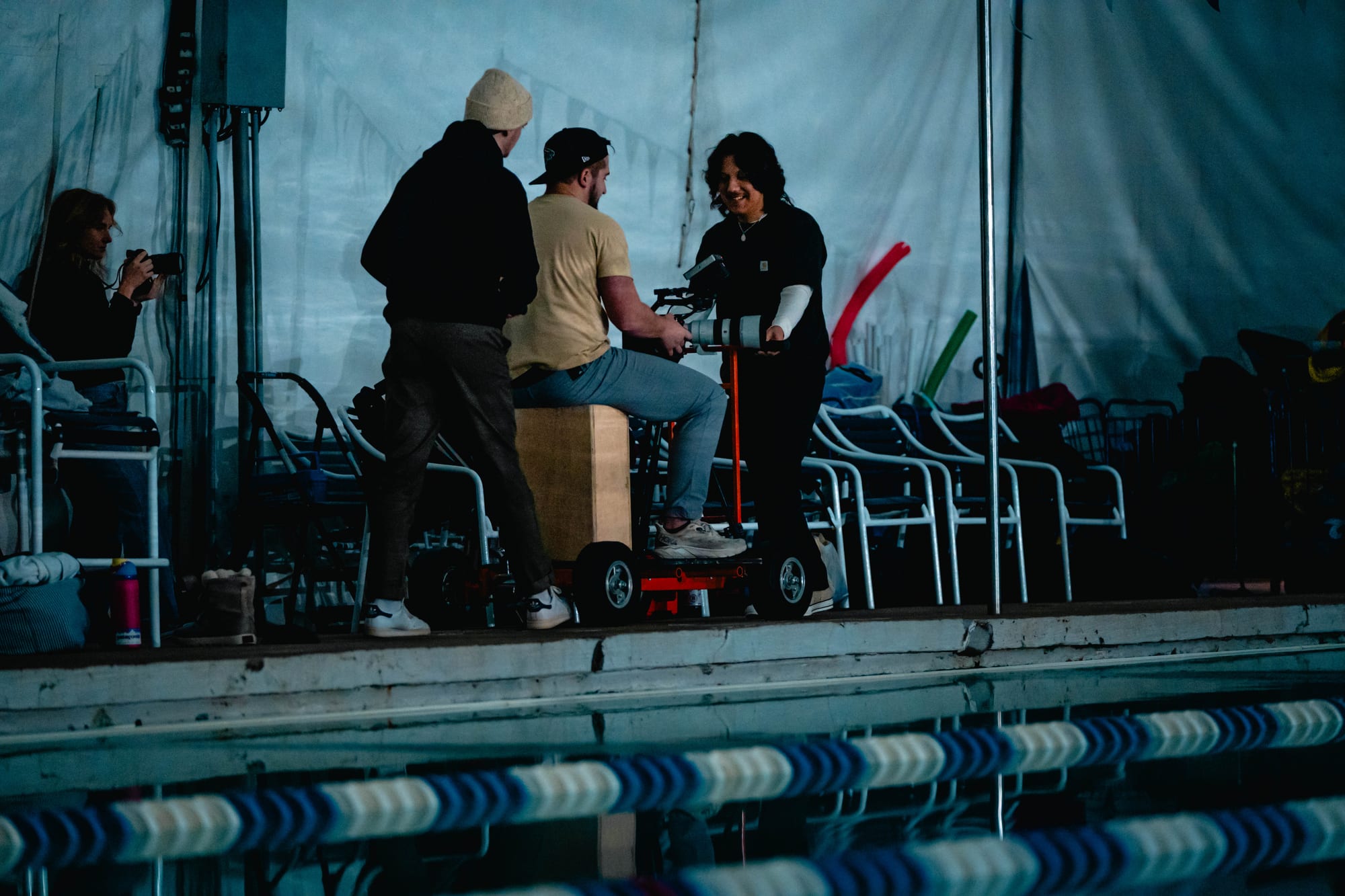 Crew adjusting swim goggles for a shot
