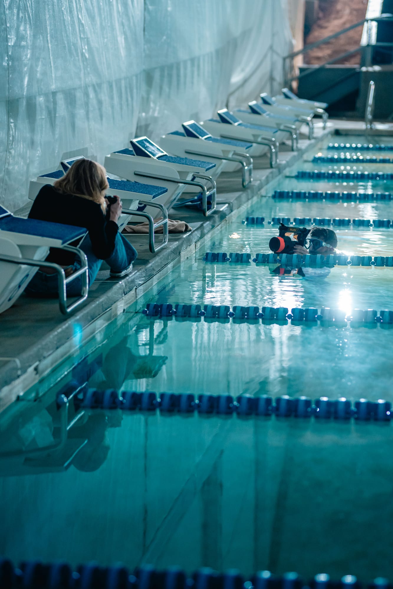 Underwater photographer shooting a swimmer in the pool
