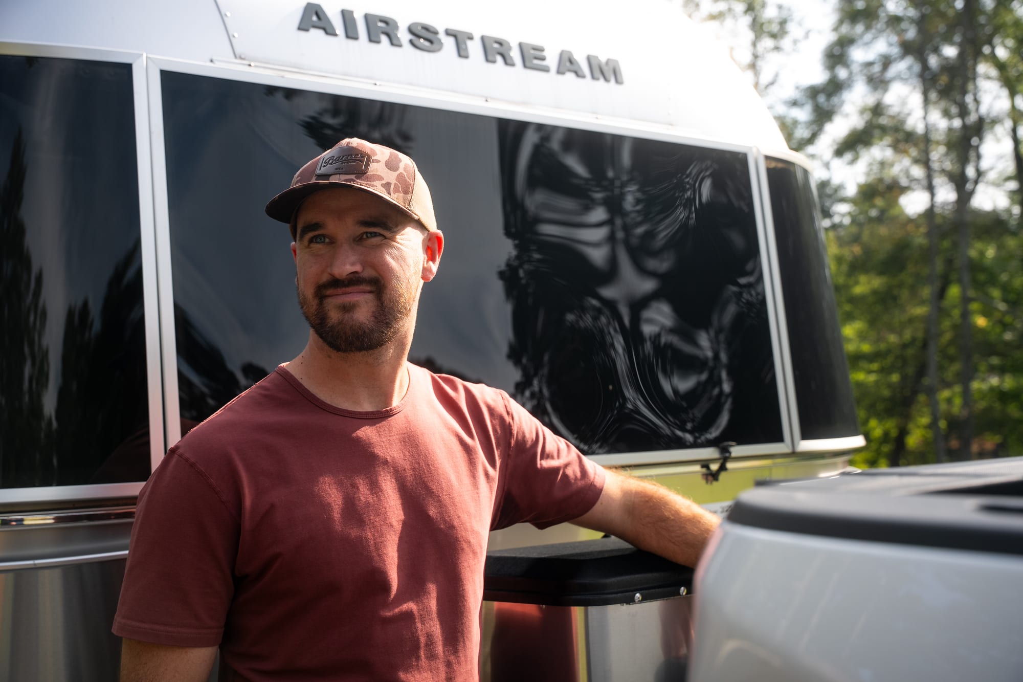 Man standing by an Airstream camper