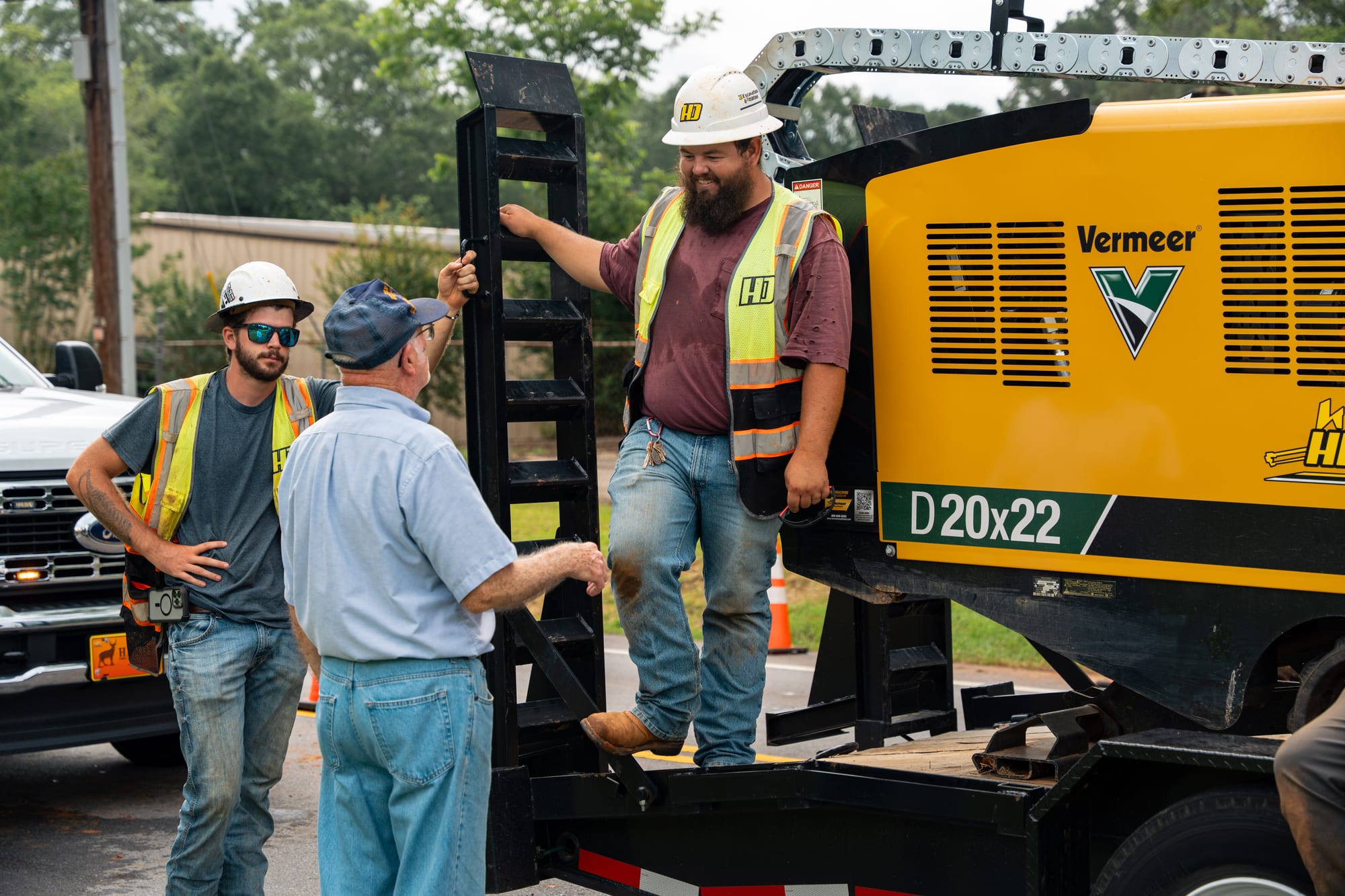 Crew talking beside drilling equipment