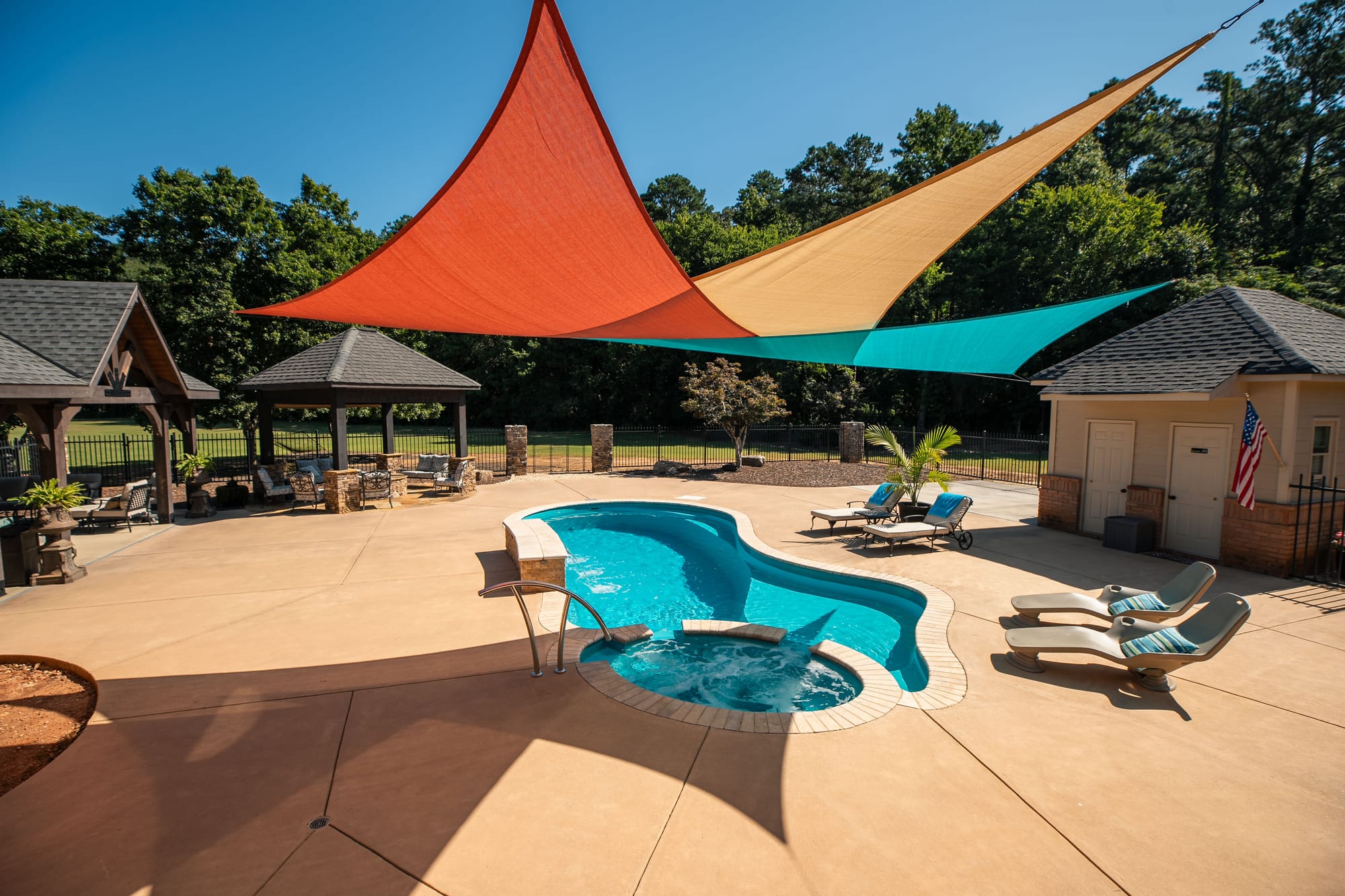 Backyard pool with shade sails
